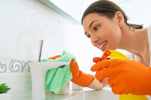 Cleaner tidying a modern Fulham apartment