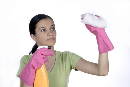 Cleaner wearing PPE during a safe cleaning task